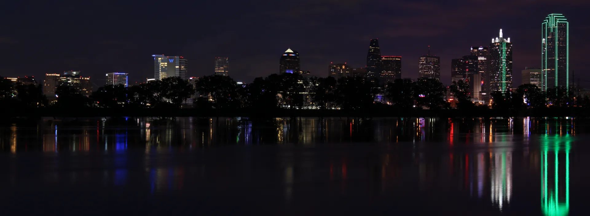 Dallas skyline illuminated above the Trinity River at night